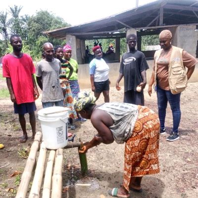 Villagers learning the process of cleaning hands